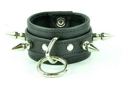 Black leather bracelet w/ leather strap layer, single row of silver spikes and silver O ring detail