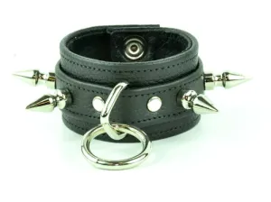 Black leather bracelet w/ leather strap layer, single row of silver spikes and silver O ring detail